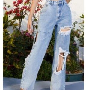 Flare ripped jeans on the front and side of the pants legs